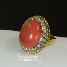 Thank you for coming in! Pretty orange red Coral diamond Vintage 14k yellow gold Ring! The coral is in an oval shape and is surrounded by sparkly white round diamonds. Ring Size: 6.25Total Weight: 12 gramsPrecious Metal: 14k solid goldPrecious stones:-Coral Center Stone: 20.1mm x 15mm, 14.2 carats-White Round diamonds: 0.73 caratsHallmark: 585, 14k Red Oval Diamond Ring With Pave Setting, Red Oval Jewelry With Pave Setting, Oval Red Jewelry With Pave Setting, Elegant Oval Coral Rings, Elegant Coral Oval Rings, Formal Coral Oval Jewelry, Coral Oval Jewelry For Weddings, Oval Orange Diamond Jewelry, Gold Ring Vintage