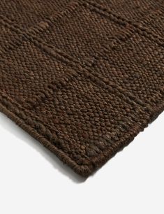 a close up view of a brown area rug