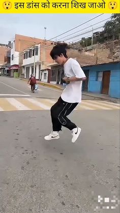 a young man is running in the street