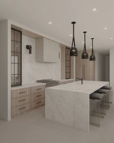 an empty kitchen with marble counter tops and stools