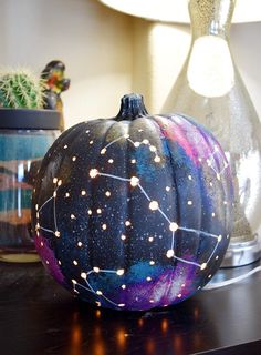 a painted pumpkin sitting on top of a table