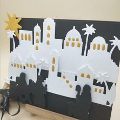 a white and black paper cut out of a city