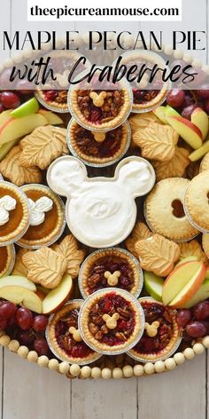 mickey mouse pies with cranberries and apples in the middle on a platter