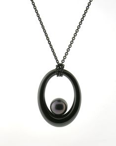 Ceramic & Pearl Necklace - A beautiful 8mm dark color cultured Chinese freshwater pearl perfectly complements the flowing form of this black gem ceramic pendant. The pendant comes as shown, on a blackened sterling silver chain. This is the all black version of Etiennes Ceramique Pearl pendant, which is very edgy and perfect for a woman or a man. Luxury Black Tahitian Pearl Necklaces, Formal Black Tahitian Pearl Necklaces, Luxury Black Necklace With Pearl Pendant, Elegant Black Pendant Pearl Necklace, Black Tahitian Pearl Necklace With Pendant, Black Pearl Round Pendant Jewelry, Black Round Pearl Pendant Jewelry, Black Pearl Pendant Jewelry, Black Tahitian Pearl Pendant Necklace