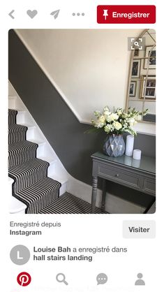 the stairs are painted black and white with flowers in vases on each one side