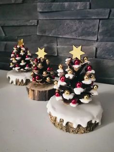 three small christmas trees sitting on top of a table