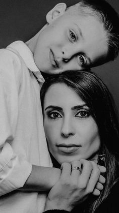 a man and woman are posing for a black and white photo