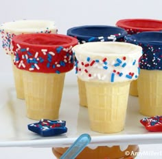 cupcakes decorated with red, white and blue sprinkles on a tray