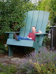 a man sitting in a blue adiron chair