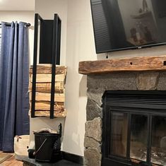 a living room with a fire place and television mounted on the wall