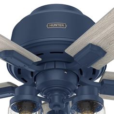 a blue ceiling fan with three light bulbs and two wood blades on the top of it