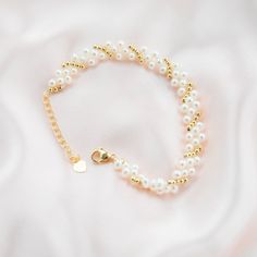 This beautiful bracelet features three layers of delicate baby pearls, delicately strung on a gold plated chain. The bracelet is accented with gold beads, adding a touch of luxury to the piece. The perfect accessory for any occasion, this bracelet will add a touch of elegance to any outfit. The pearls are of highest quality, lustrous and of round shape, perfect for everyday wear or as a special gift. Pearl Type: Freshwater Pearls Pearl Quality: [Shape]: Round [Pearl Size]: 3-4mm [Blemish]: Minim Gold Pearl Charm Chain Bracelet, Party Pearl White Beaded Bracelets With Pearl Chain, Party Pearl White Beaded Bracelets, Elegant Multi-strand Beaded Bracelets, Gold Pearl Bracelet With 14k Gold Filled Pearl Chain, Gold 14k Gold Filled Pearl Chain Bracelet, Gold Pearl Chain Bracelet In 14k Gold Filled, Pearl Bracelets With Tiny Beads For Wedding, Party Pearl Bracelet With Gold Round Beads