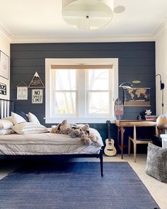 a bedroom with black walls and white trim