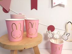 some pink cups with bunny ears on them