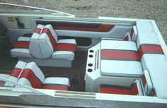 the interior of a boat with red and white seats