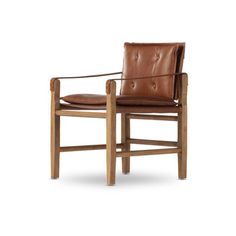 a brown leather chair sitting on top of a wooden frame