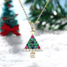 Enjoy the magic of Christmas with this spirited tree pendant. Bright and colorful, this Christmas tree pendant is sure to showcase your sense of holiday cheer. A combination of green, blue, red and white stones, the necklace will show a very sparkling look on your neck. A festive look that will go with any outfit, this sterling silver christmas tree necklace will be a lovely gift for her this December!Carat Weight: 3.615 ctStone Size: 4*4,2.8,3.5,2.8,2.8,2.8 mmStone Type: Jeulia® StoneNumber of White Pendant Jewelry For Christmas, Elegant Multicolor Jewelry For Holidays, Elegant Multicolor Holiday Jewelry, Multicolor Christmas Jewelry Gift, Multicolor Jewelry Christmas Gift, Green Festive Jewelry For New Year, Green Holiday Jewelry Gift, Elegant Multicolor Christmas Jewelry, Holiday Gift Green Jewelry