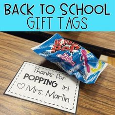 back to school gift tags on a desk with candy bar in the middle and blue background