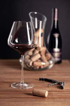 a wine glass and corks on a table