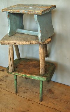 an old wooden chair sitting on top of a wooden floor next to a white wall