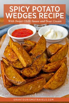 baked sweet potato wedges with chili sauce and sour cream on a white platter