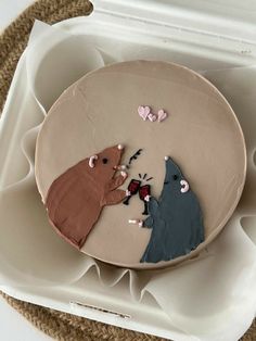 a cake decorated to look like two bears in the middle of a conversation on a plate