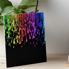 rainbow rain drops falling down on black background art board with white vase and green plant