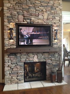 a fireplace with a television mounted above it