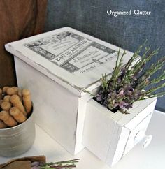 an old box is used as a planter with dried flowers in it and other items