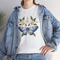 Discover timeless beauty with our Elegant Butterfly & Flowers T-Shirt, designed for both men and women. Featuring a delicate butterfly fluttering among a bouquet of vibrant flowers, this unisex tee offers a touch of nature's grace to your everyday wardrobe. Crafted from soft, premium fabric for all-day comfort, it's perfect for casual wear or as a charming gift for nature enthusiasts. Available in a range of sizes, this shirt is a wonderful way to showcase your love for nature and add a touch of elegance to your style. White Butterfly T-shirt For Spring, Spring Crew Neck T-shirt With Butterfly Embroidery, Spring Butterfly Embroidered Crew Neck T-shirt, Delicate Butterfly, Vibrant Flowers, Elegant Shirt, Butterfly Flowers, Charm Gift, Premium Fabric