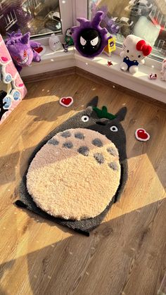 the rug is shaped like a totoro and has been placed on the floor