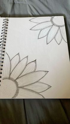 a drawing of two sunflowers on a sheet of paper next to each other