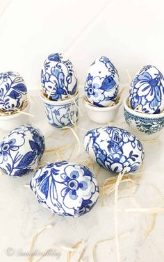 blue and white fabric covered buttons with floral designs on them, sitting on a table