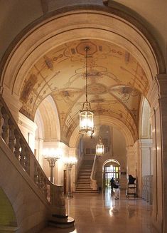 an ornate hallway with chandeliers and marble flooring is pictured in this image