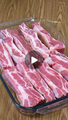 raw meat in a glass dish on a wooden table