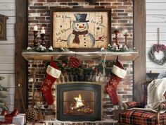 a fireplace decorated for christmas with stockings and stocking