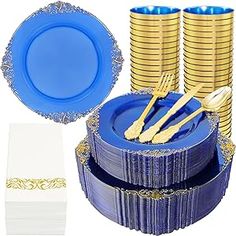 a blue and gold table setting with plates, napkins, forks and place mats