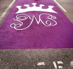 a purple parking lot with a white crown painted on it