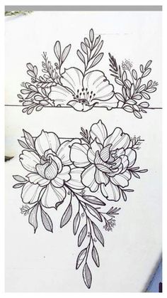 some flowers and leaves are drawn on a piece of paper with pencils next to it