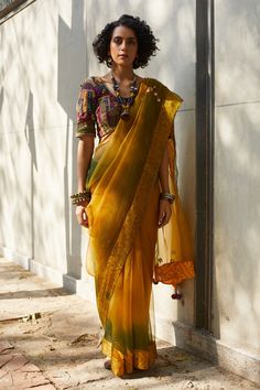 Ombre yellow, green dyed saree with mirror embroidery, bandhani print border and tassel pallu. Paired with patchwork hand embroidered blouse.
Component: 2
Embroidered
Neckline: Scoop neck
Sleeve Length: Short
Fabric: Silk Organza, Cotton
Color: Yellow
Patchwork blouse
Note: Neckpiece worn by the model is not for sale - Aza Fashions Organza Saree With Blouse, Ombre Saree, Green Sari, Patch Work Blouse, Yellow Saree, Yellow Silk, Green Hand, Stylish Sarees, Embroidered Neckline