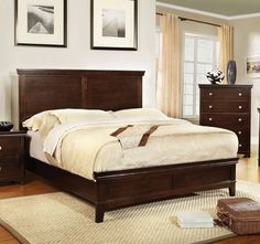 a bed room with a neatly made bed and two night stands on top of it