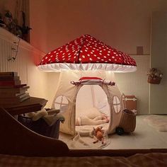 a red and white mushroom shaped lamp in the corner of a room with a baby's bed