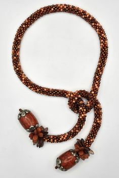 Beaded Necklace - A mixture of hundreds of orange glass seed beads are crocheted into this tweed-look rope.  It ends in two silver-capped bone beads from Bhutan, surrounded by a fringe of Czech glass leaves and daggers.  Shorter in length, it is easy-to-wear. Crochet Rope, Silver Caps, Artful Home, Bone Beads, Crochet Dog, Bhutan, Glass Seed Beads, Beading Patterns, Wire Jewelry