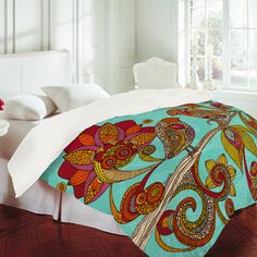 the comforter is made up with colorful paisley designs