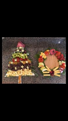 two trays filled with different types of food on top of a granite countertop