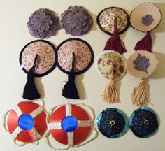 there are many different items hanging on the wall, including hats and brooches