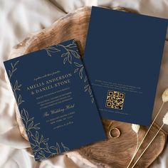 two blue wedding cards on a wooden tray