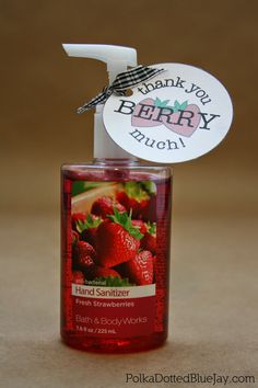 a bottle of bath and body works strawberry berry muffins on a brown surface