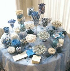 a table topped with lots of blue and white desserts