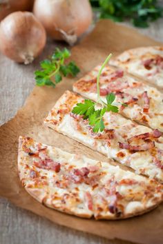 the pizza is sliced and ready to be served on the cutting board with parsley